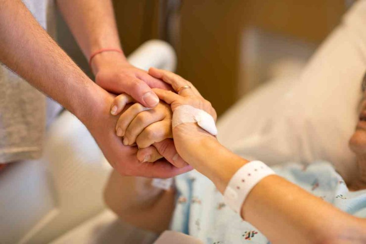 Anziano nel letto d'ospedale